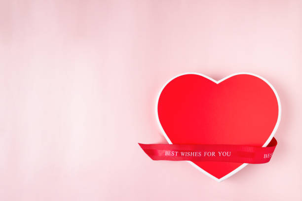 istock red heart shaped gift box on pink background, copy space 1391764348