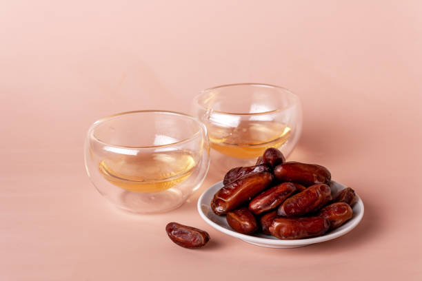 istock green chinese tea in glass cups and a plate with dates 1391764424