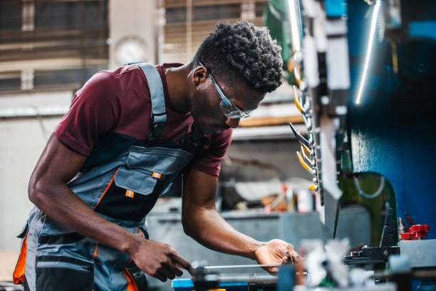 istock Afroamerican bluecollar worker in a factory 1391764555