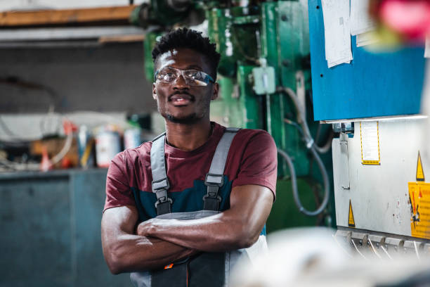 istock Afroamerican bluecollar worker in a factory 1391764559