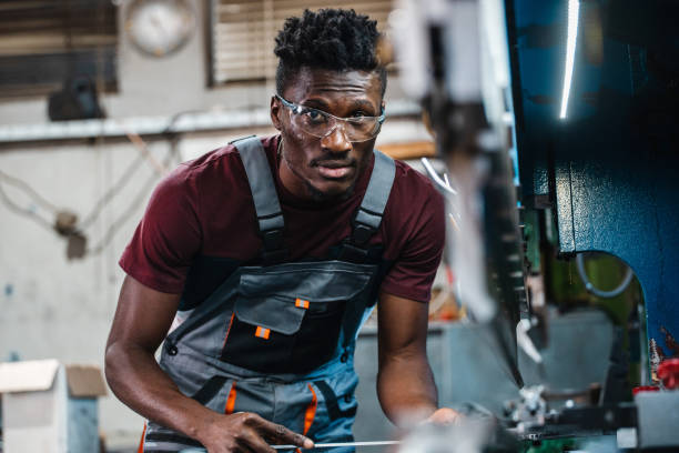 istock Afroamerican bluecollar worker in a factory 1391764561