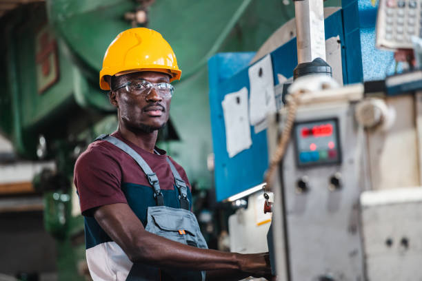Afroamerican bluecollar worker in a factory stock photo
