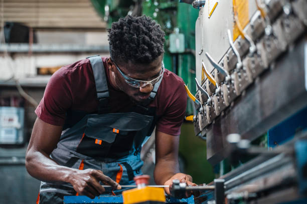 istock Afroamerican bluecollar worker in a factory 1391765128