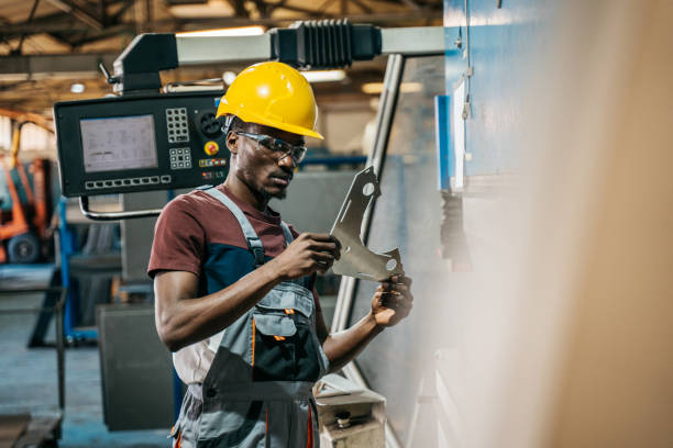 istock Afroamerican bluecollar worker in a factory 1391765322