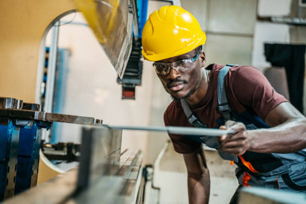 istock Afroamerican bluecollar worker in a factory 1391765323