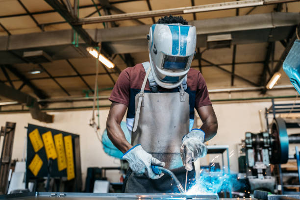 afro american welder - protective glove machinist human hand african descent imagens e fotografias de stock