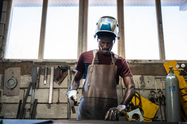 afro american welder - protective glove machinist human hand african descent imagens e fotografias de stock