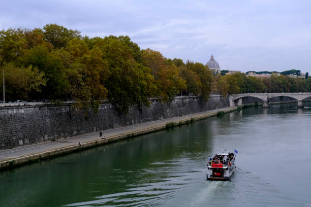 Touristic boat sailing on Tiber river in Rome, Italy on Oct. 31, 2021.