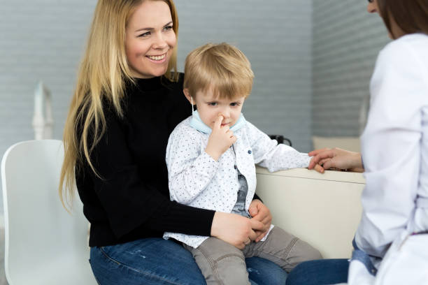istock A boy picks his nose at a doctor's appointment. 1391767096