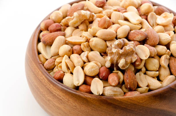 istock Mixed nuts in Wooden bowl on white background. 1391768050