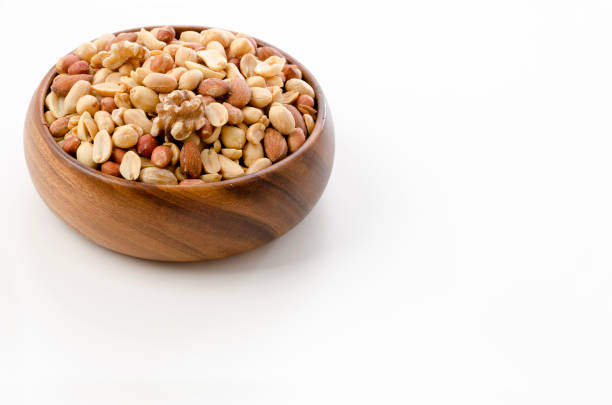 Mixed nuts in Wooden bowl on white background.