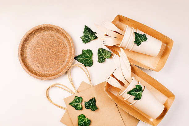 istock Eco craft paper tableware,cups,fast food containers.Recycling,eco-friendly concept.Disposable eco cutlery,plates,spoons,knives,forks on a light background.Craft paper bag for food delivery.Copy space. 1391769766