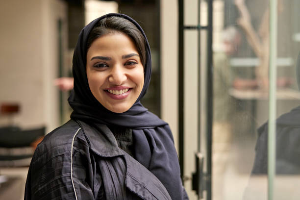 Indoor portrait of cheerful Saudi woman in mid 20s stock photo