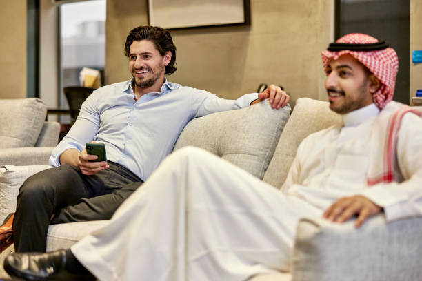 istock Relaxed Saudi businessmen sitting on sofa in modern office 1391771188