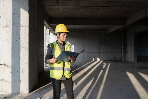 istock An Asian female engineer was looking at a construction site file 1391773528