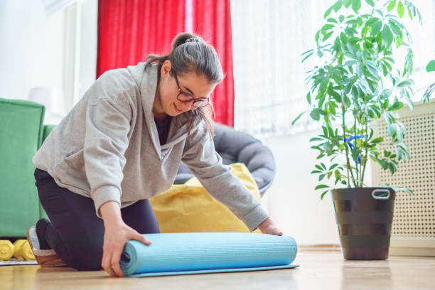 istock Woman exercise at home with a blue mat 1391774116