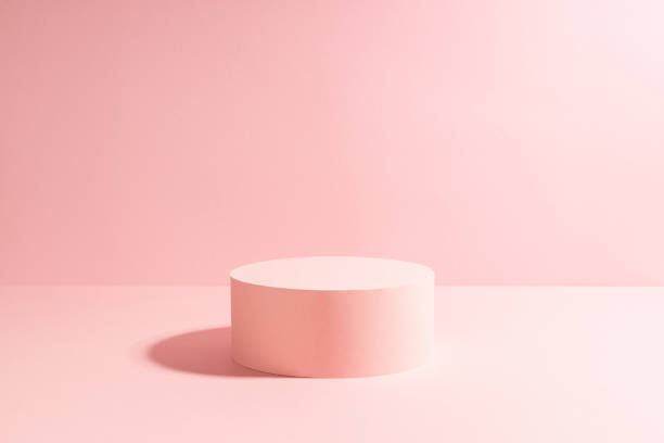 istock Elegant pastel pink circle single podium mockup in sunlight with shadow on soft light sunny background, copy space. Template scene for advertising, presentation cosmetic product or goods, design. 1391774686