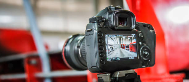 istock Photographer and videographer holding camera, take photo or record video 1391776500