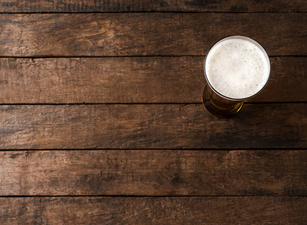 istock Beer glass on wooden table. Close up 1391776521