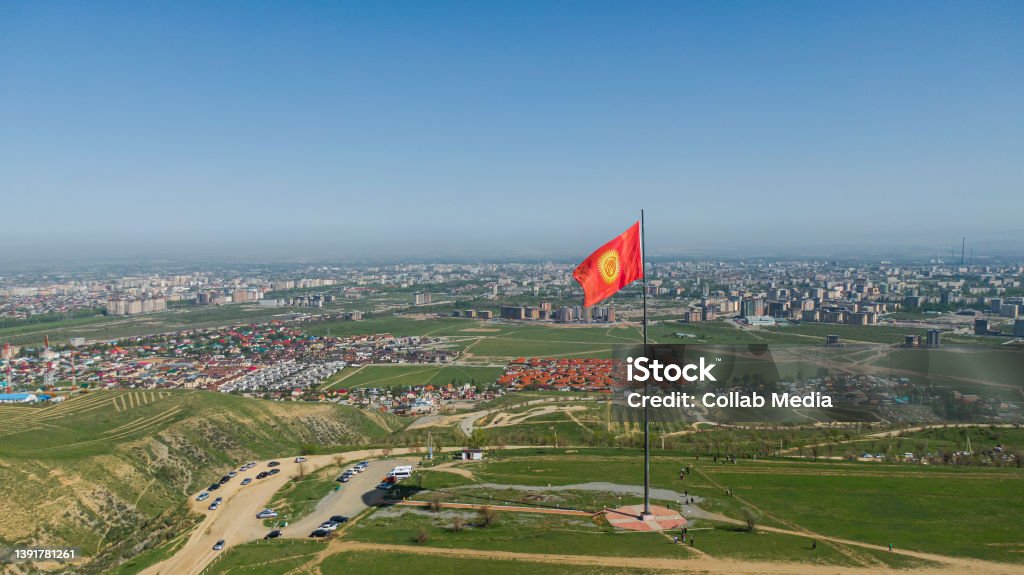 Aerial view of Bishkek city from the mountains. Flagpole with Kyrgyzstan flag Kyrgyzstan Stock Photo