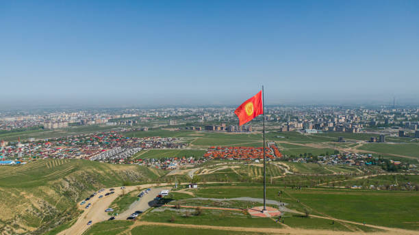 Aerial view of Bishkek city from the mountains. Flagpole with Kyrgyzstan flag Aerial view of Bishkek city from the mountains. Flagpole with Kyrgyzstan flag bishkek stock pictures, royalty-free photos & images