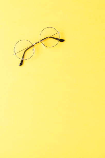 istock Fashion eyeglasses on yellow background with copyspace 1391783384