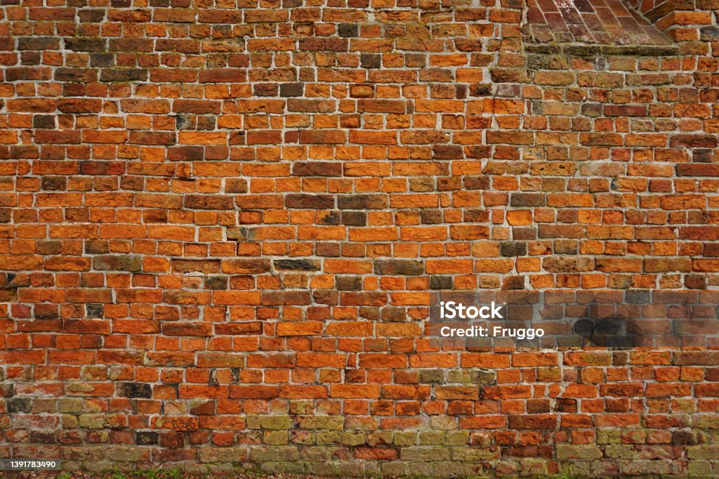 Brick wall detail of a church Old church wall, patched and repatched throughout the centuries. Video Conference Background Stock Photo
