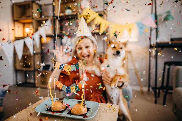 Happy young woman celebrating dog birthday
