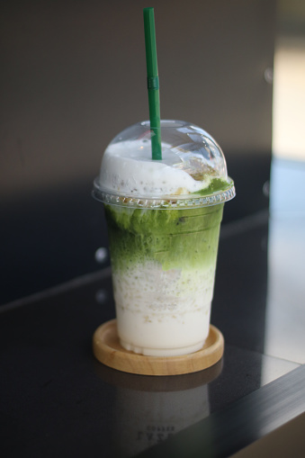 Iced matcha green tea with green straw