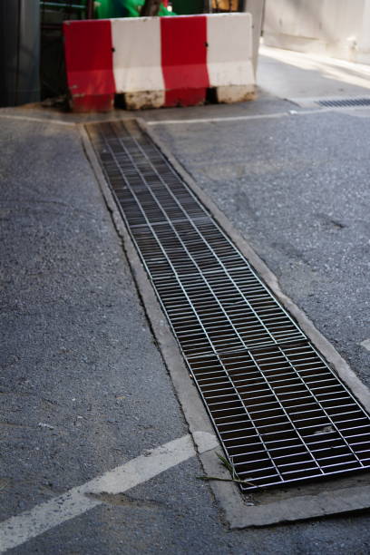 istock Metal drain or grate on asphalt road 1391786398