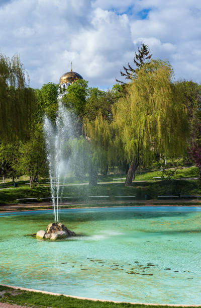 istock Kamianets-Podilskyi,  Khmelnytsky region, Ukraine. Beautiful spring city park with  blossoming sakura or cherry blossom tree near fountain. 1391787664