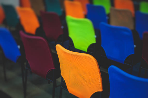 Empty modern conference hall, venue for congress lecture, with a line row of chairs, auditorium before the convention event, interior of a place for presentation with lot of seats and no people