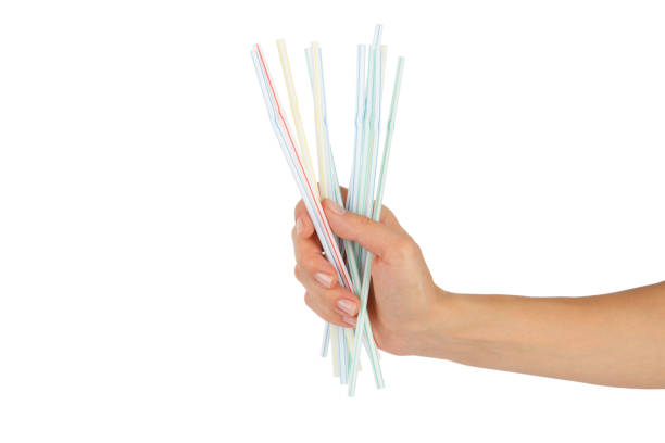 istock Colored drinking straws in the hand on white background 1391790294