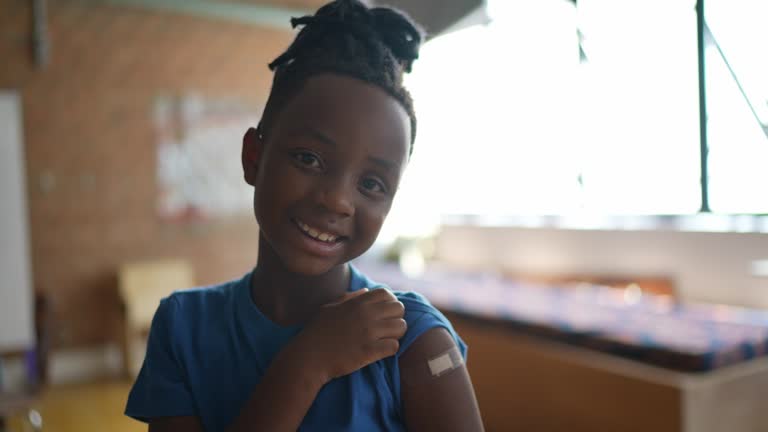 Portrait of a boy showing his arm after vaccination