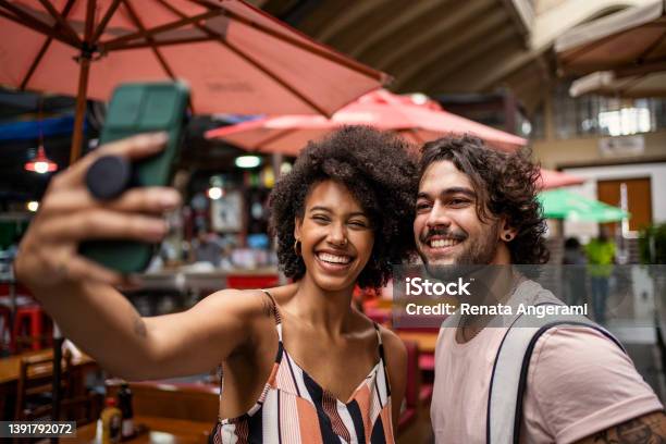 Portrait Of Beautiful Tourist Couple Making Selfie In The Municipal Market Stock Photo - Download Image Now