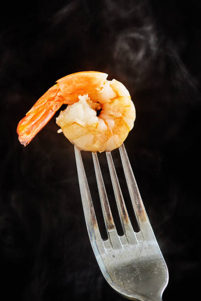 Steam rises from a freshly cooked pink shrimp.