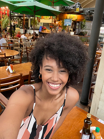 Portrait of beautiful woman making selfie in the municipal market of São Paulo