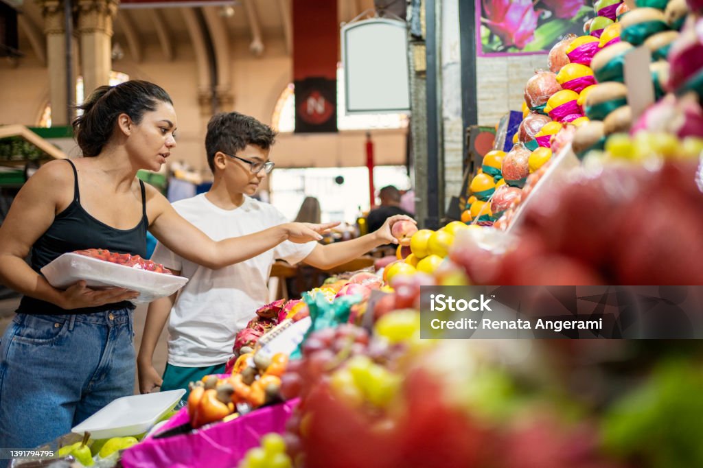 Mother and son buying fruits at the municipal market Supermarket Stock Photo