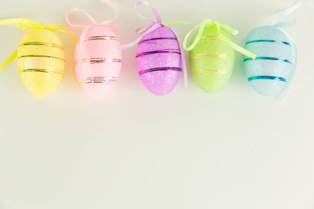 A close-up of beautifully decorated Easter eggs in various colors and patterns, set against a vibrant blue background with a bokeh effect. The pastel hues and playful designs create a joyful and festive mood, perfect for Easter celebrations, spring themes, and holiday decorations.