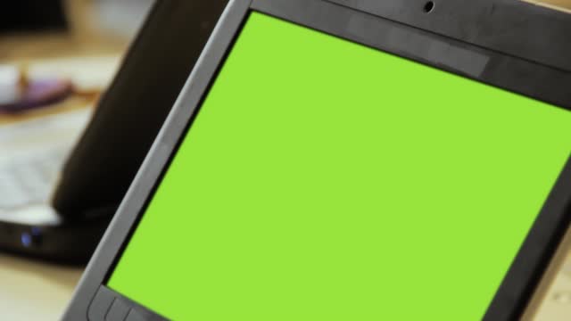 Netbook with Green Screen in School Class. Close Up. Zoom In. You can replace green screen with the footage or picture you want.
