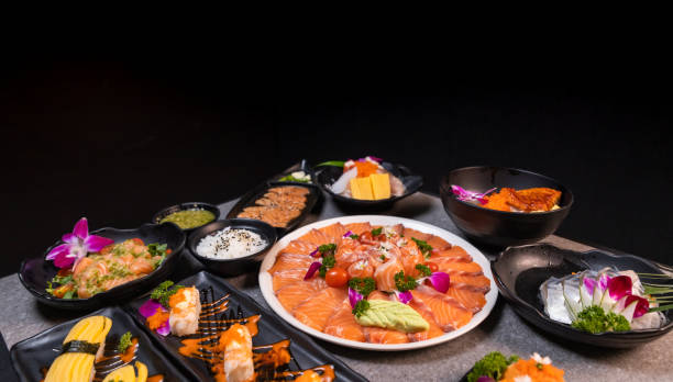 istock Sashimi sushi set with soy on black background.Assorted sushi set served on dark stone slate background. Top view 1391796809