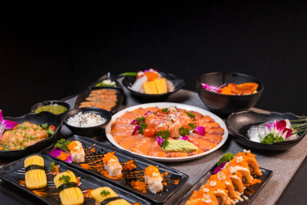 istock Sashimi sushi set with soy on black background.Assorted sushi set served on dark stone slate background. Top view 1391796832