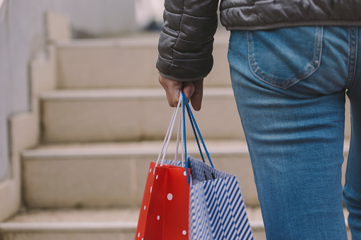 Adult female carrying shopping bags