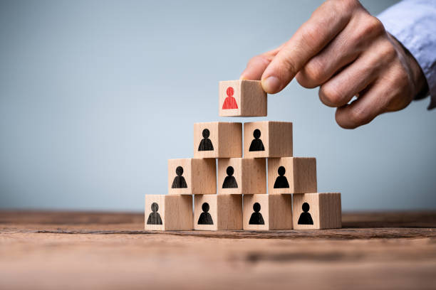 istock Hand Building Business Pyramid With Blocks 1391809114