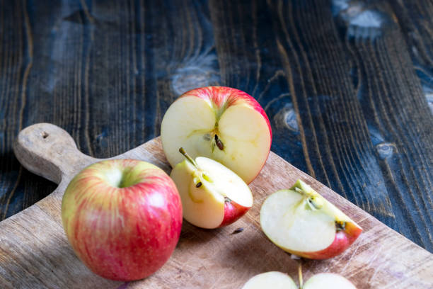 istock cutting old board with pieces of red ripe apple 1391809375