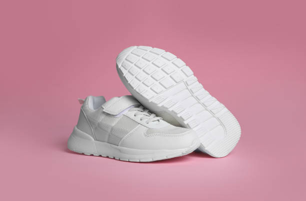 istock Pair of stylish sneakers on pink background 1391810529