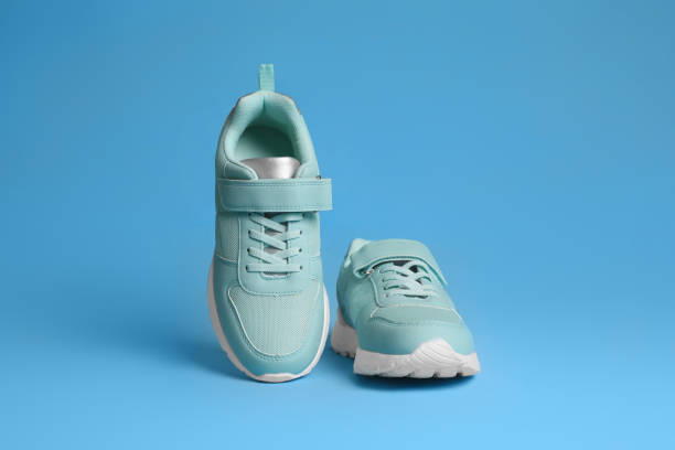 istock Pair of stylish sneakers on light blue background 1391811007