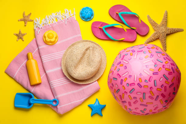 istock Flat lay composition with beach ball and sand toys on yellow background 1391813467