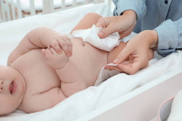 istock Mother changing baby's diaper on table at home, closeup 1391813621