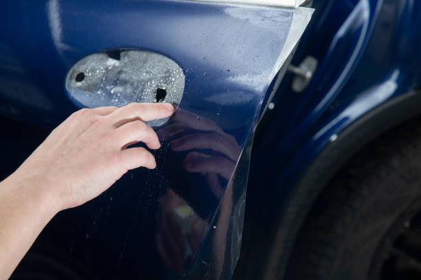 istock Installing a protective film on the car. 1391820033